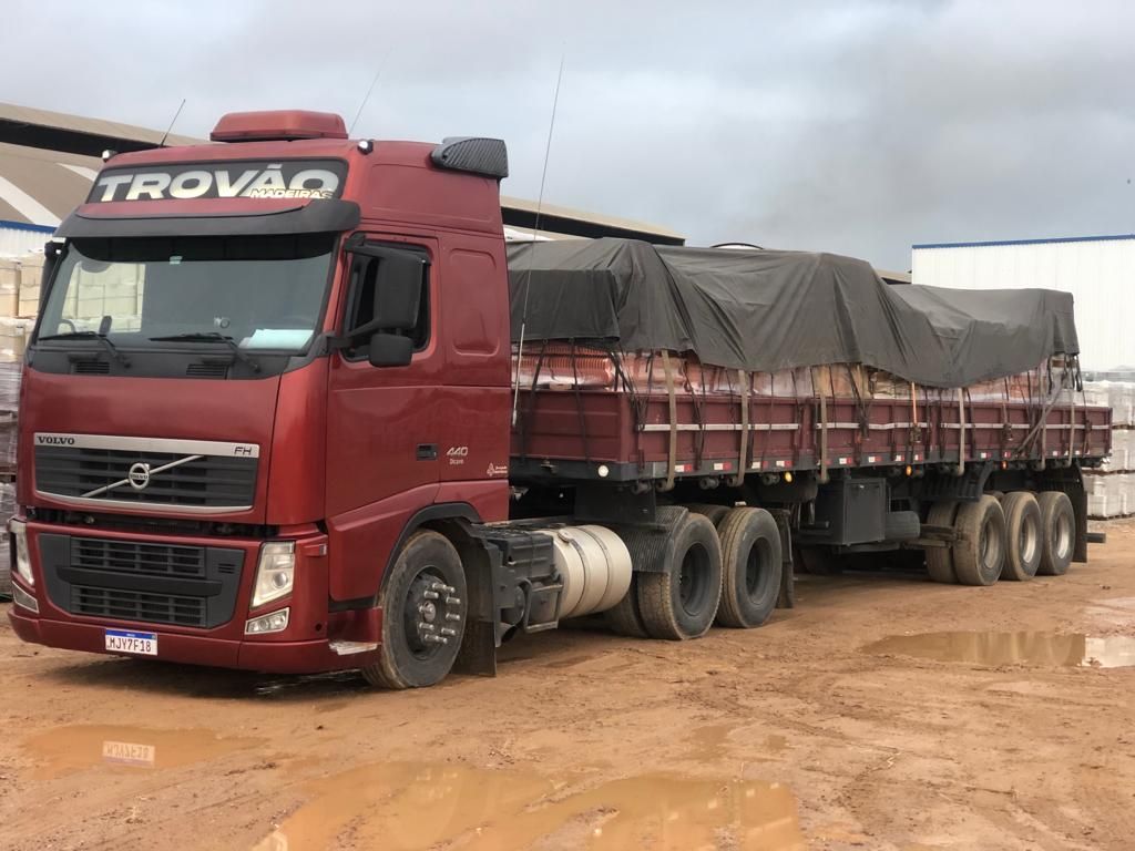 Carreta Volvo da Trovão Madeiras, carregada e encerada, parada no pátio da loja